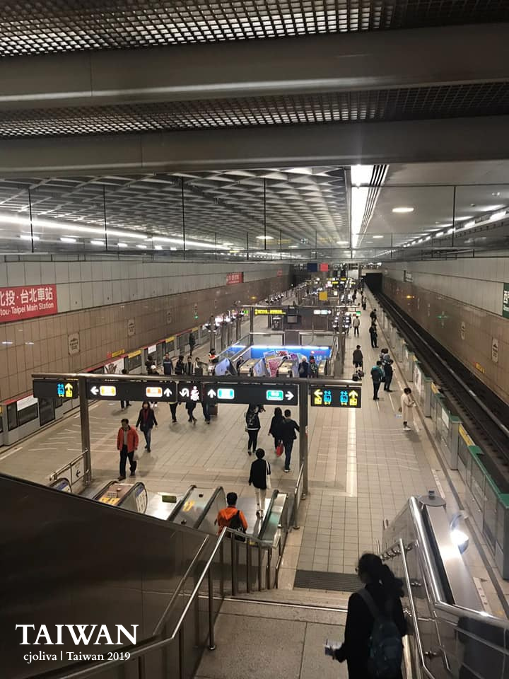 A wide-angle view of the busy Taipei Main Station transit hub in Taiwan, showing commuters on escalators and platforms, used as a metaphor for navigation in a blog post.