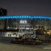 Night view of Busan Station in South Korea with illuminated "Busan is good" sign and blue lights on the station roof.