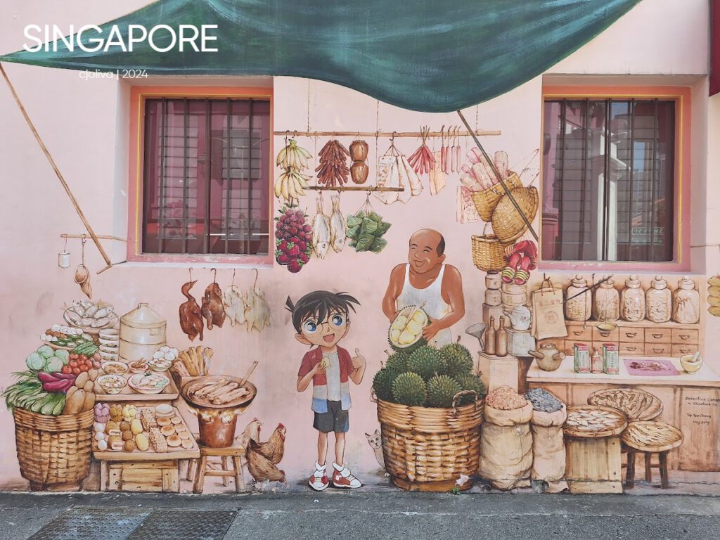 Vibrant mural in Singapore depicting a traditional market scene with durians, vegetables, baked goods, and cultural motifs.