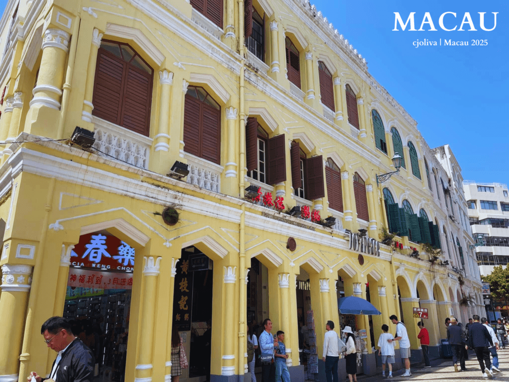 Senado Square in Macau with a yellow colonial building, Farmacia Weng Chong, and the Santa Casa da Misericórdia landmark.