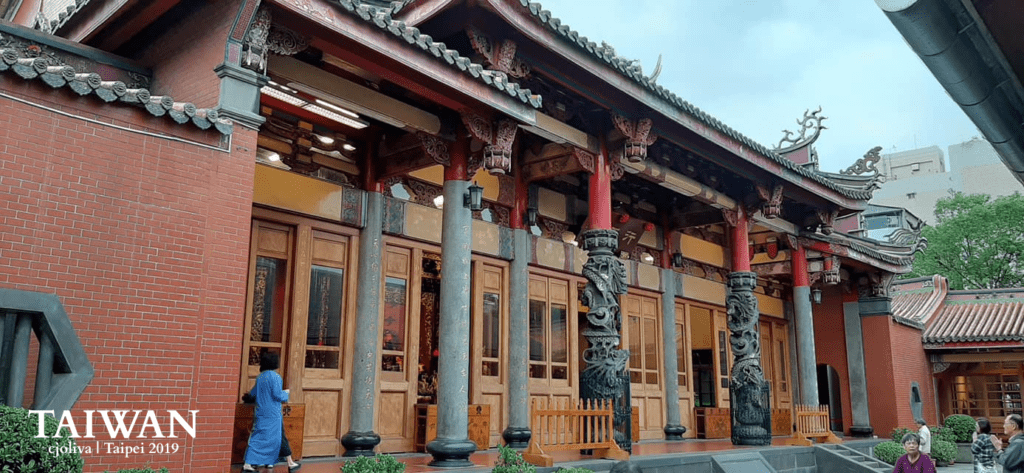 Xingtian Temple with ornate columns, dragon carvings, and decorative roof eaves in Taipei, Taiwan.