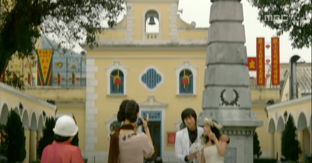 The bright yellow and white Baroque-style Chapel of St. Francis Xavier in Coloane Village, Macau, known as the final wedding filming location for the Korean drama Princess Hours (Goong).