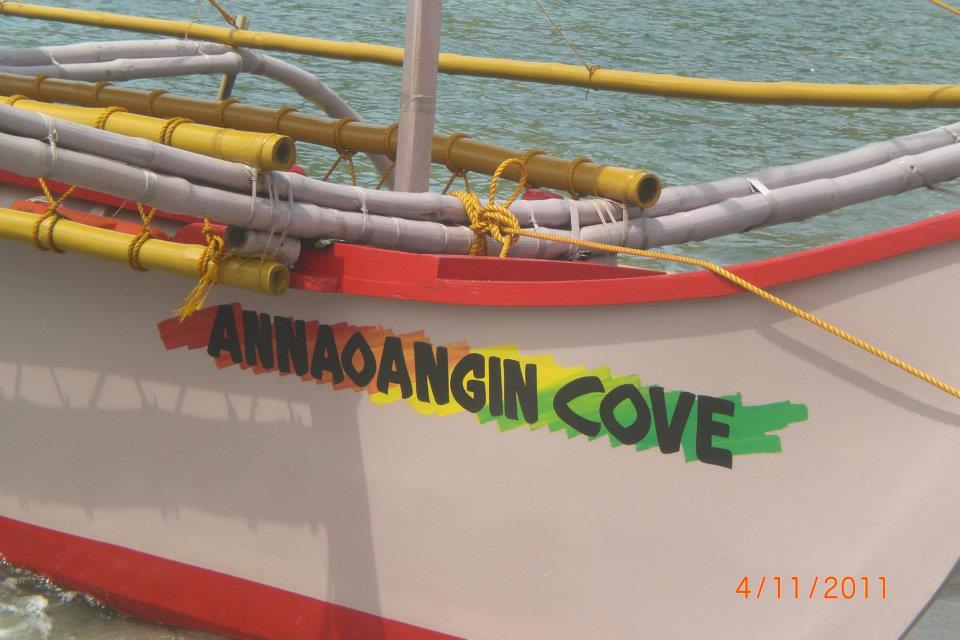 Philippine outrigger banca with colorful trim docked at Annaoangin Cove, dated April 11, 2011