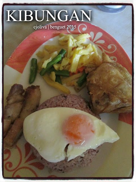 Plate of traditional Filipino breakfast from Kibungan, Benguet, featuring fried egg, rice, fried chicken, pork tapa, and sautéed vegetables.