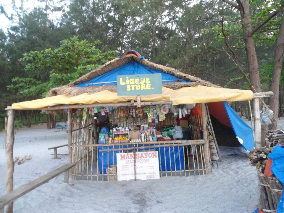 Rustic bamboo Ligaya Store at Mansayon Beach Resort with entrance fee banner and tropical setting