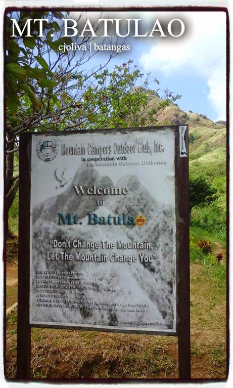 A welcome signboard at Mt. Batulao with inspirational quote and trail information, surrounded by greenery