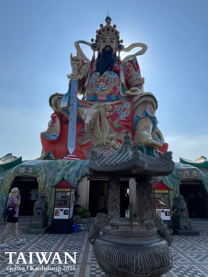 Massive colorful statue of a seated deity holding a sword at the North Pole Emperor Temple in Kaohsiung, Taiwan.