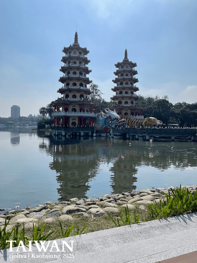 Dragon and Tiger Pagodas at Lotus Pond in Kaohsiung, Taiwan, with ornate carvings, colorful towers, dragon and tiger entrances, and reflections in the water.