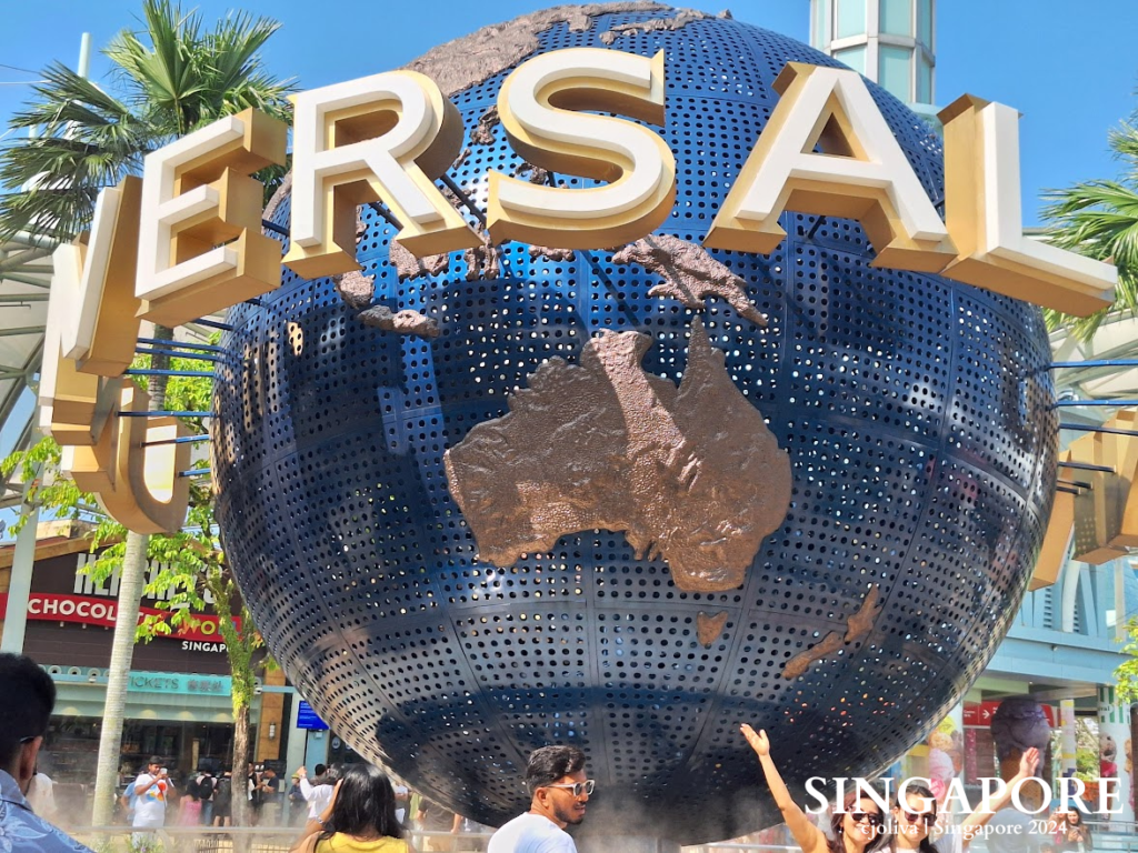 The iconic rotating Universal Studios globe at Resorts World Sentosa, Singapore, on a sunny day.