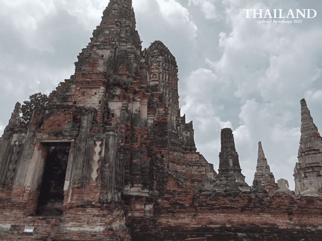 Ancient temple prang with weathered brick and stucco at Ayutthaya Historical Park, Thailand