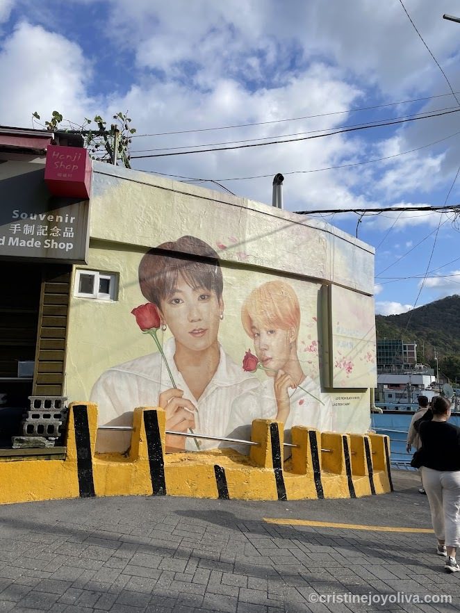 Mural of BTS members Jungkook and Jimin holding red roses on Henji Shop building in Busan, South Korea