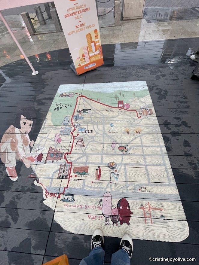 Illustrated city tour map in Korea with cartoon characters and landmarks