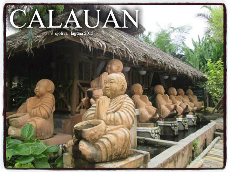 A row of terracotta monk statues holding bowls beside a water feature at Calauan cultural site in Laguna, Philippines