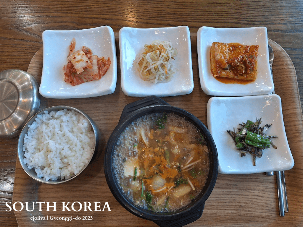 Doenjang-jjigae is a traditional Korean meal in Gyeonggi-do, South Korea, with rice and assorted side dishes on a wooden tray.