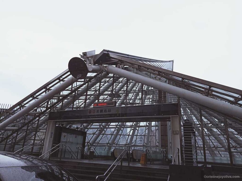 Entrance of Formosa Boulevard Station in Kaohsiung, Taiwan with glass canopy and escalator