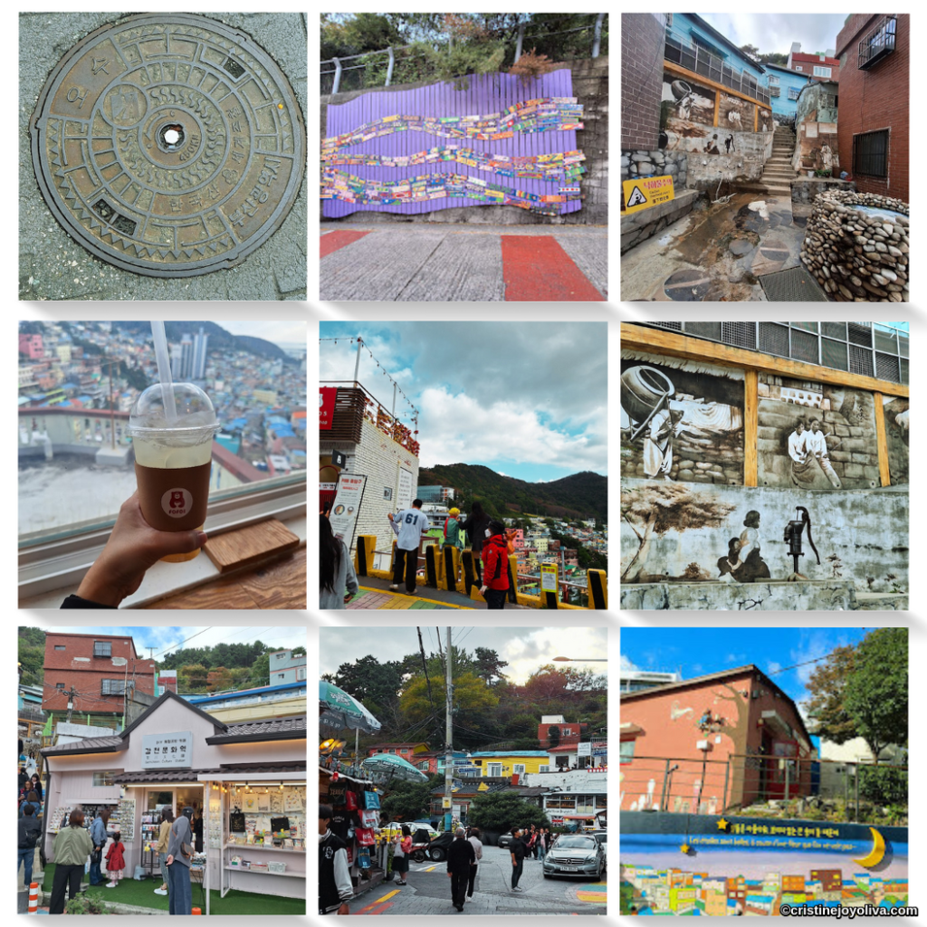 A nine-image photo collage capturing a variety of scenes and details from Gamcheon Culture Village in Busan, South Korea. Clockwise from top-left: A ornate, circular metal manhole cover with Korean script; A wavy, purple-painted wall mural with colorful, small panels; A view up a narrow, tiered alleyway past a stone wishing well and historic mural; A multi-level, black and white mural titled 'Aroma of Gamcheon'; A bright, reddish-orange brick building under a cloudy sky with a painted moon; A view down a main street with pedestrians and parked vehicles; A small, white building (Gamcheon Cultural Center) with shops and people out front; a close-up of a hand holding an iced coffee in a clear plastic cup from FOFO cafe, overlooking the village; the central image is a group of people standing on a street overlooking the valley of colorful houses.