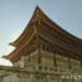 Gyeongbokgung Palace traditional Korean architecture with intricate green and red woodwork under a clear sky in Seoul.