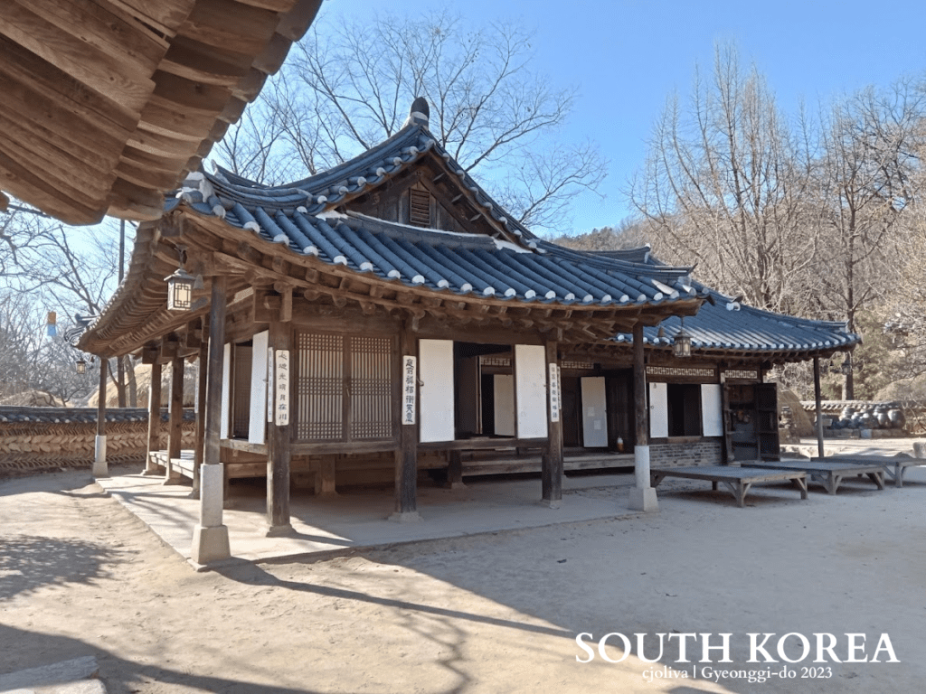 Traditional Korean hanok house with tiled roof, wooden beams, and paper windows at Korean Folk Village in Gyeonggi-do, South Korea, 2023