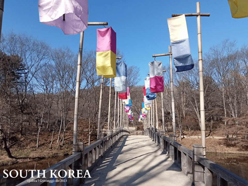 Scenic pathway decorated with colorful lanterns on bamboo poles at Korean Folk Village in Gyeonggi-do, South Korea, 2023