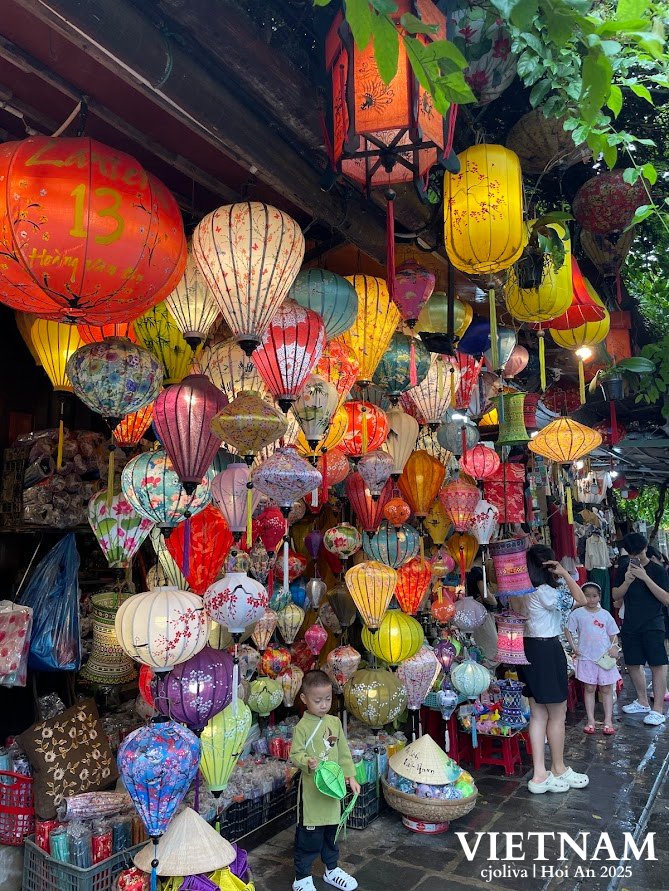 Collage of colorful silk and paper lanterns at a Hội An street market, with people admiring the display and text overlay “Vietnam cjoliva | Hội An 2025”.