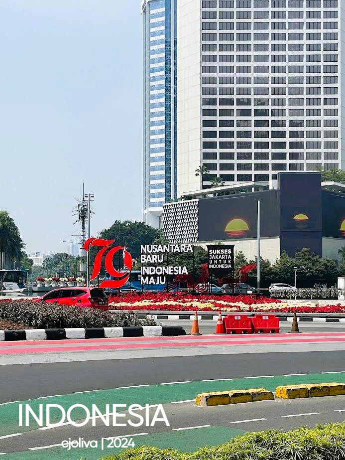 Decorative installation in Jakarta, Indonesia, celebrating the nation’s 79th anniversary with red “79” signage, flowers, and a modern skyscraper backdrop.