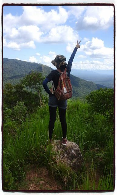 Backpacker raising a peace sign while hiking Mt. Manabu in Batangas with scenic mountain view