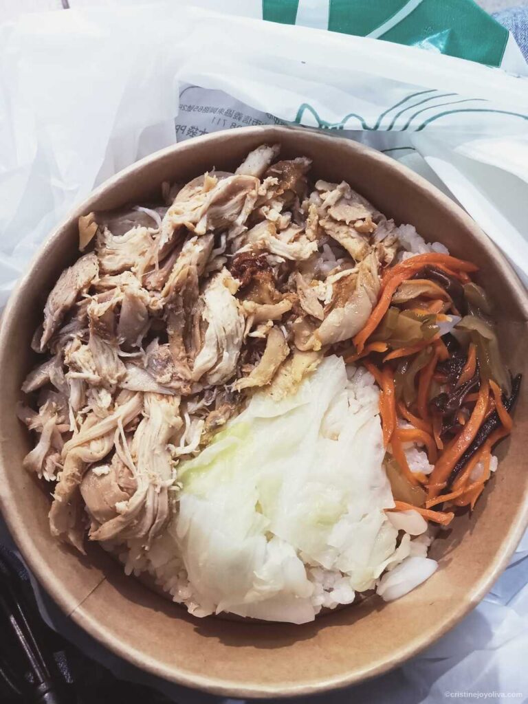 Taiwanese takeout bowl with shredded chicken, rice, cabbage, and mixed vegetables