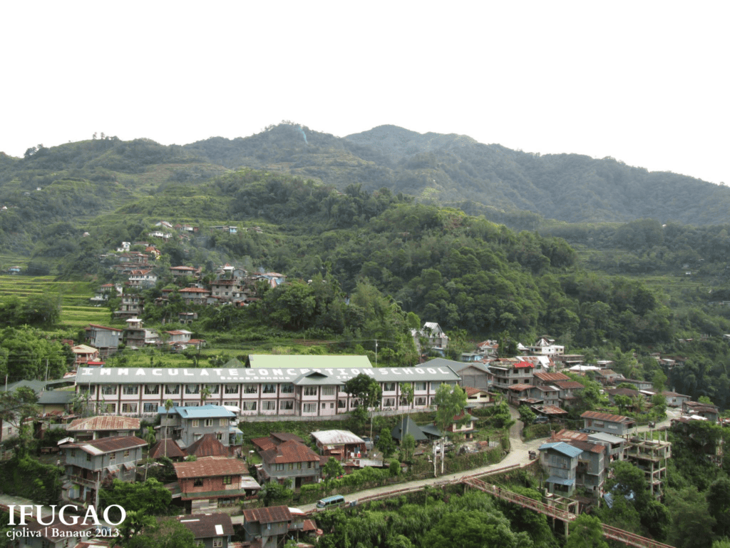 Scenic view of Immaculate Conception School nestled among mountain hillsides and homes in Banaue, Ifugao.