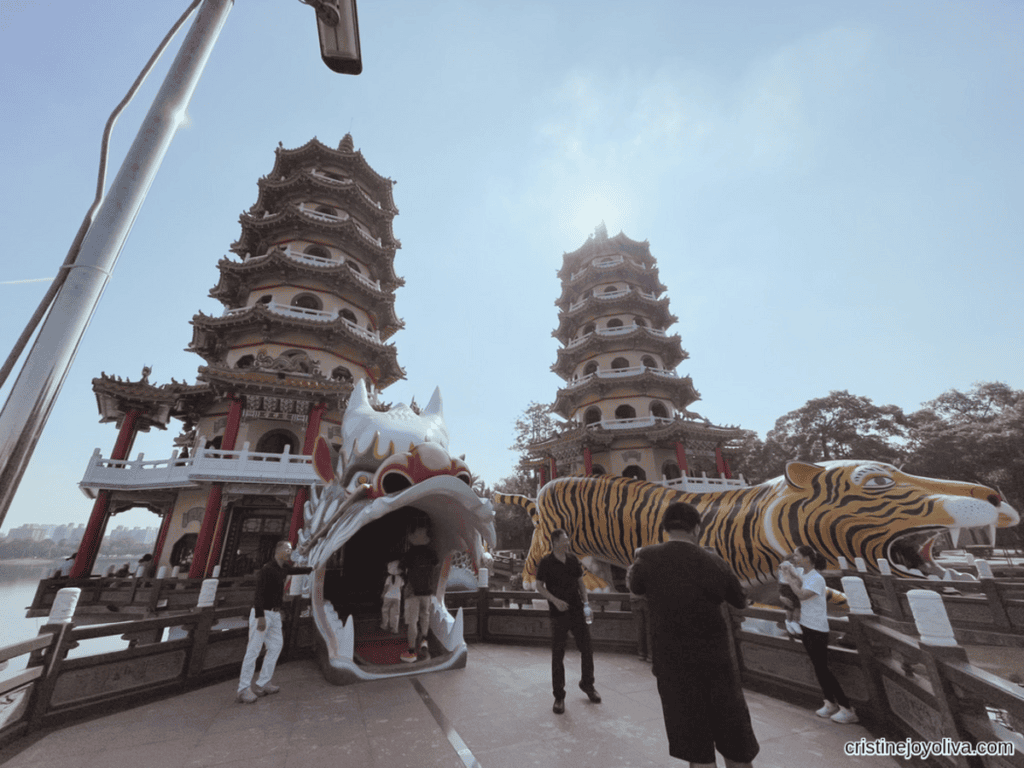 Visitors enter through the open mouth of the large dragon statue in front of the Twin Dragon and Tiger Pagodas at Lotus Pond in Kaohsiung, Taiwan.