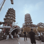 Visitors enter through the open mouth of the large dragon statue in front of the Twin Dragon and Tiger Pagodas at Lotus Pond in Kaohsiung, Taiwan.