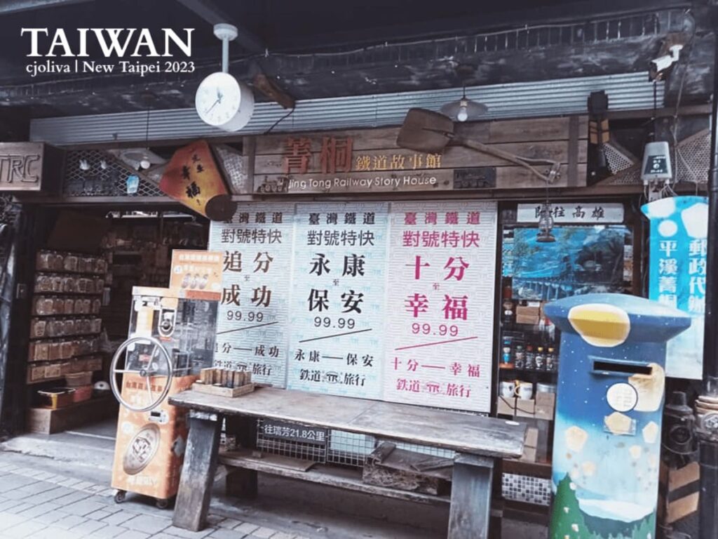 The wooden storefront of Jing Tong Railway Story House, with train-themed decor and a blue mailbox in Jingtong, Taiwan.