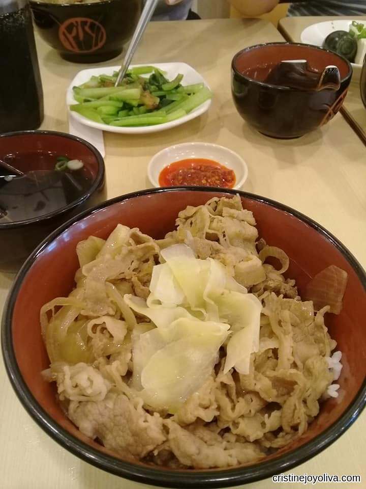 Yoshinoya beef bowl with thinly sliced beef and pickled ginger, served with side dishes in Ximending, Taiwan.