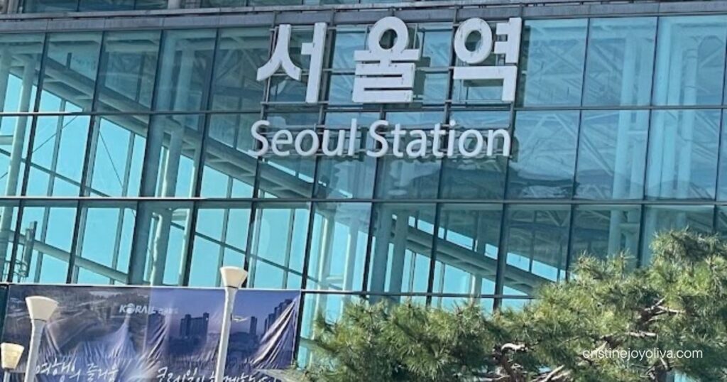 Seoul Station glass facade with English and Korean signage, the arrival point for Busan to Seoul by KTX