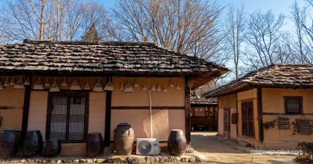 Traditional onggi earthenware jars outside a hanok cottage at Korean Folk Village Yongin.
