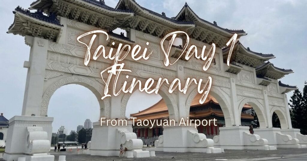 The grand white entrance arch of Liberty Square with blue tiled roofs in Taipei under an overcast sky.