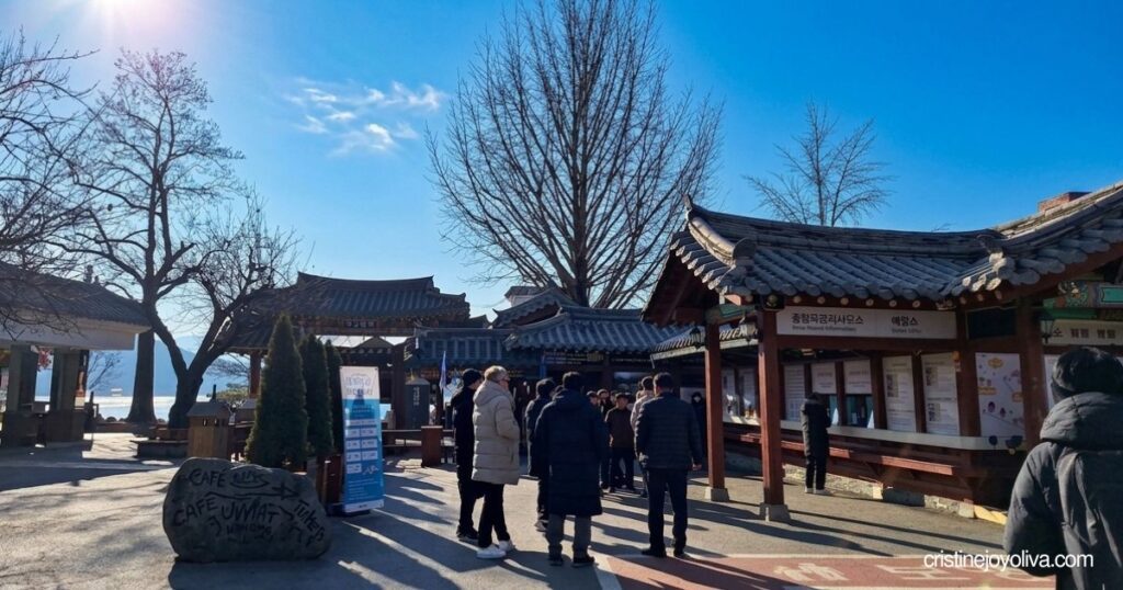 Visitors walking past traditional Korean-style ticket booths on Nami Island