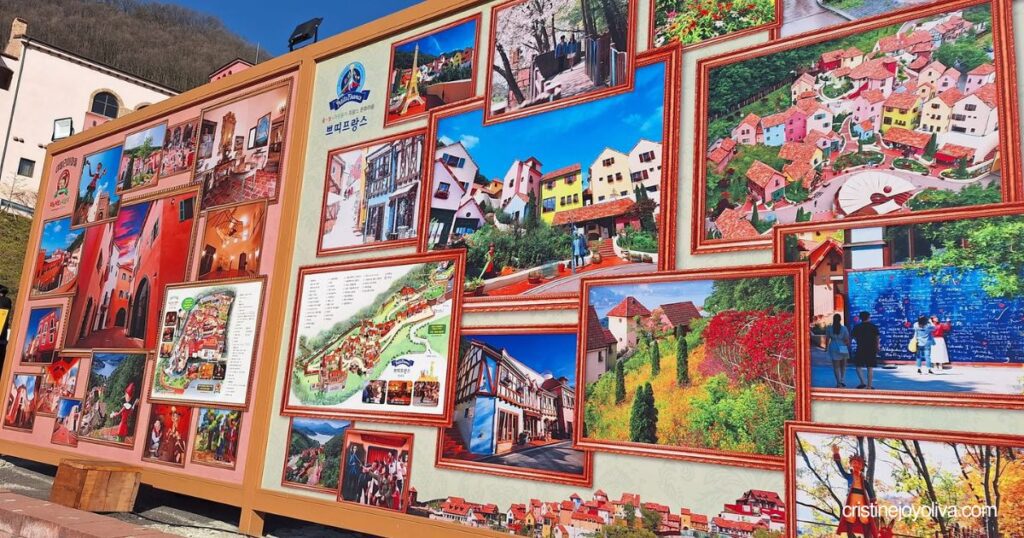 A large outdoor display board features a map and framed photographs of Petite France and Italian Village.
