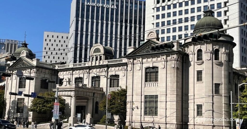 Stone Bank of Korea Money Museum building with green domes in front of the Bank of Korea skyscraper in Seoul
