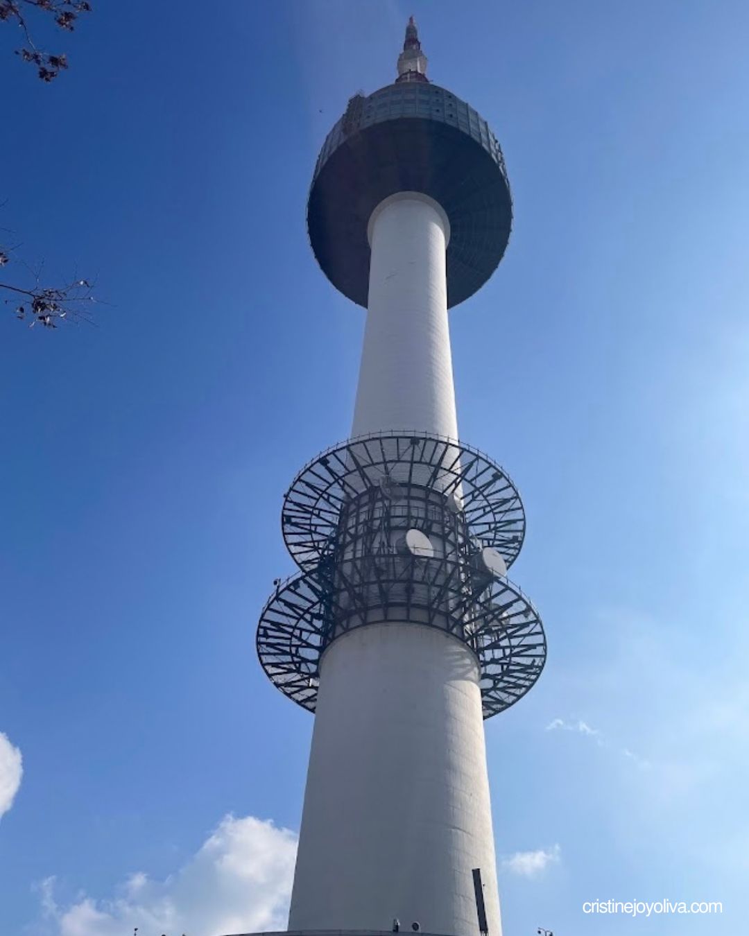 N Seoul Tower rising against a clear blue sky, seen from directly below